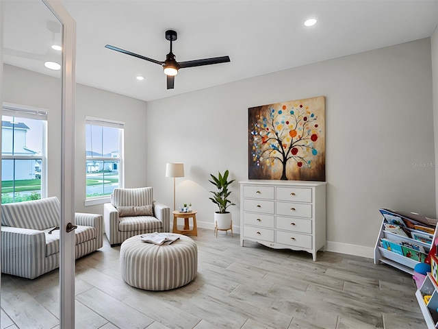 living area with ceiling fan