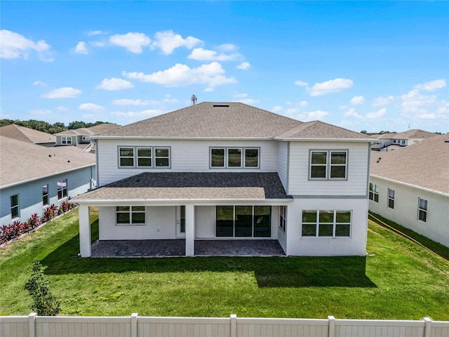 back of property featuring a patio area and a yard