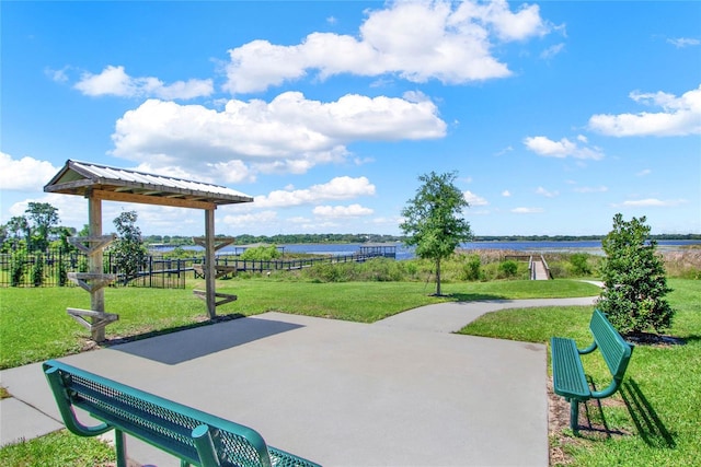 surrounding community featuring a lawn and a water view