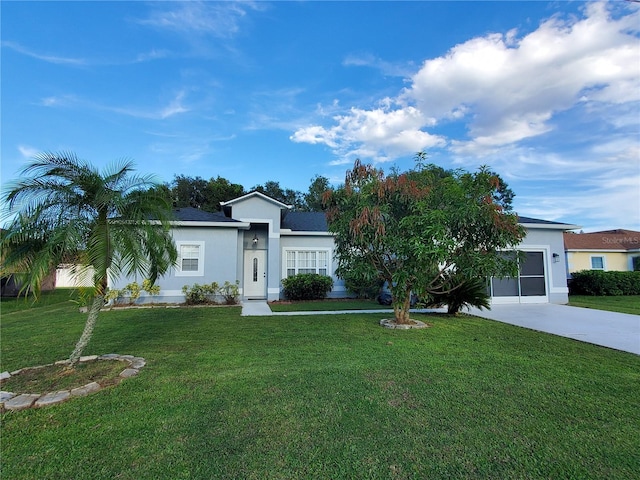 single story home featuring a garage and a front lawn