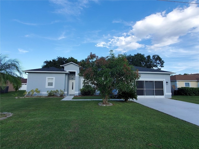 ranch-style house featuring a front lawn and a garage