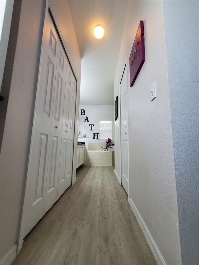 hall with light hardwood / wood-style floors