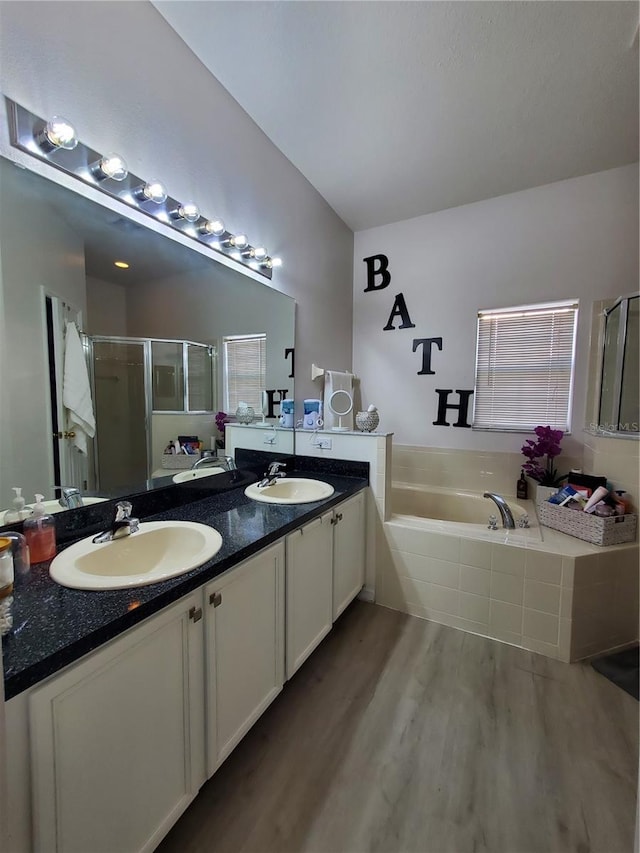 bathroom featuring vanity, separate shower and tub, and hardwood / wood-style flooring