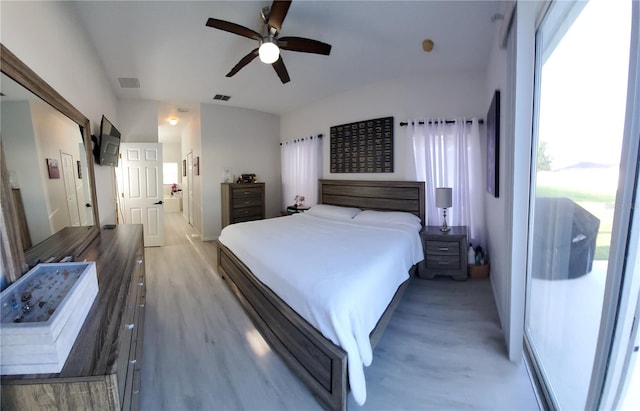 bedroom featuring ceiling fan, access to exterior, light hardwood / wood-style floors, and multiple windows