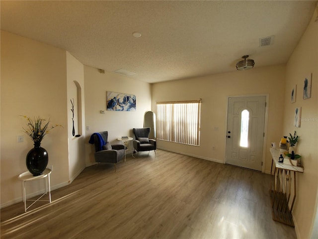 entryway featuring a textured ceiling and hardwood / wood-style floors