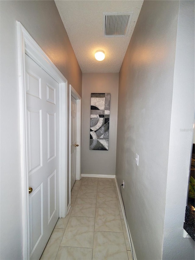 hallway featuring a textured ceiling