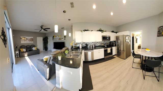 kitchen featuring pendant lighting, a breakfast bar, sink, white cabinets, and stainless steel appliances