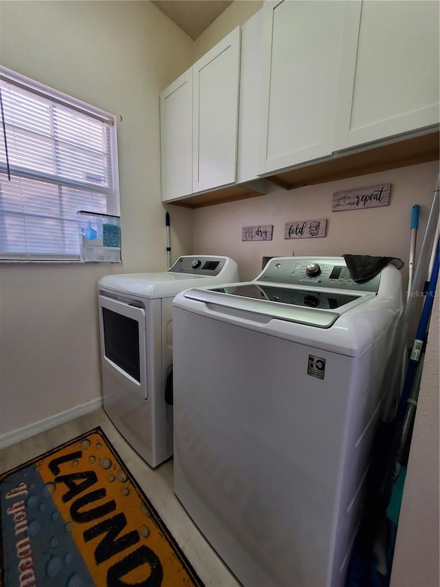 washroom with cabinets and separate washer and dryer