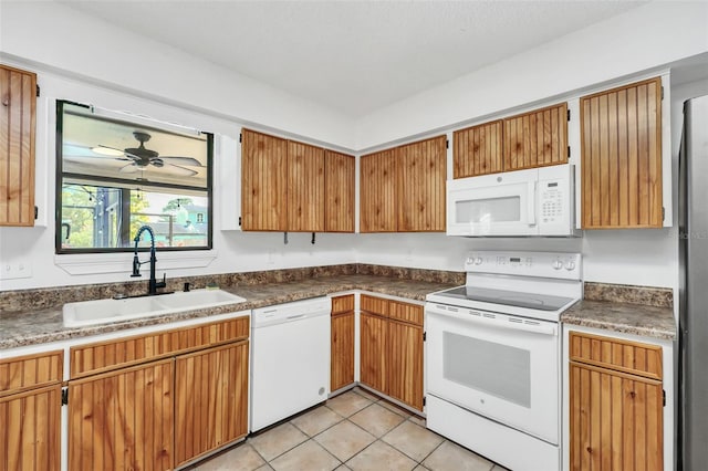 kitchen featuring white appliances, ceiling fan, light tile patterned floors, and sink