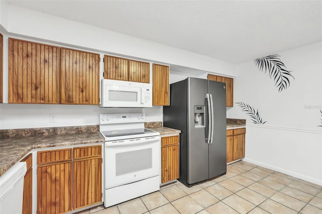 kitchen featuring white appliances and light tile patterned floors