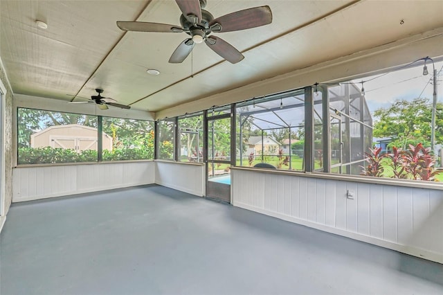 unfurnished sunroom featuring ceiling fan