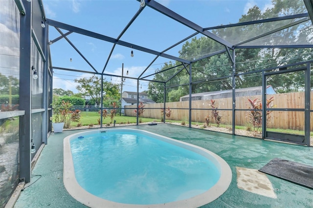 view of swimming pool with glass enclosure