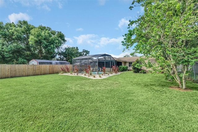 view of yard with glass enclosure