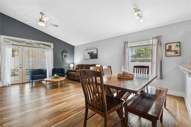 dining room featuring french doors, light hardwood / wood-style floors, lofted ceiling, and ceiling fan