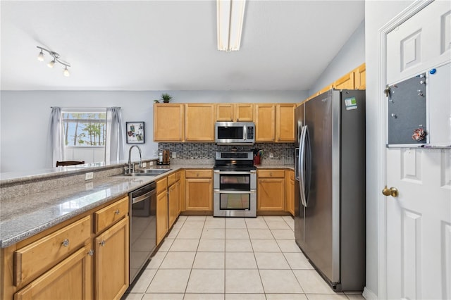 kitchen featuring decorative backsplash, stainless steel appliances, sink, light tile patterned flooring, and light stone counters