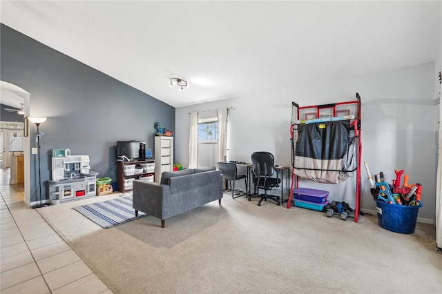 carpeted living room with lofted ceiling and ceiling fan