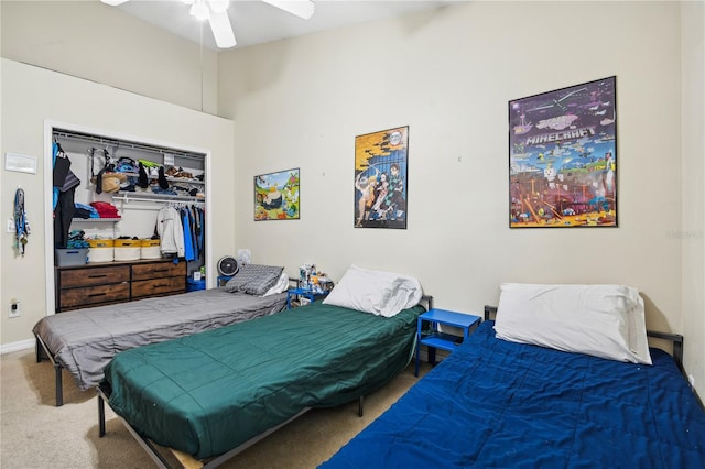 carpeted bedroom with a closet and ceiling fan