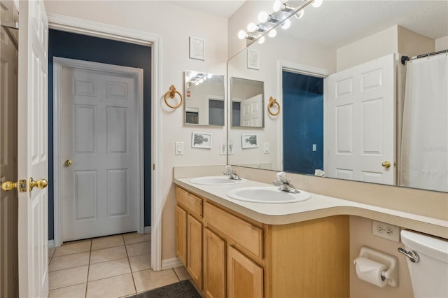 bathroom featuring vanity, toilet, and tile patterned floors