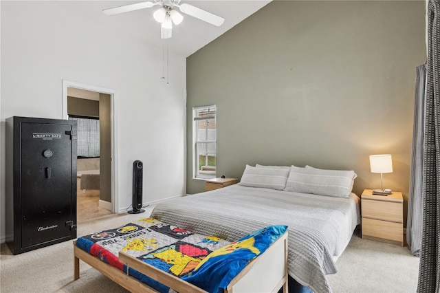 bedroom featuring ensuite bathroom, high vaulted ceiling, carpet flooring, and ceiling fan