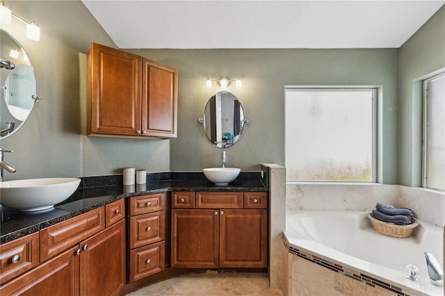 bathroom with vanity and tiled bath