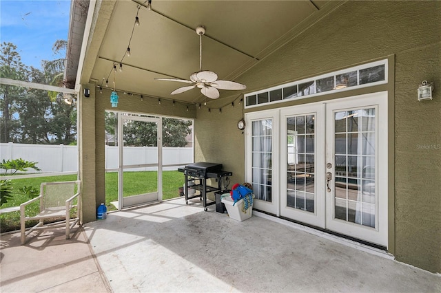 sunroom / solarium featuring french doors, ceiling fan, and vaulted ceiling