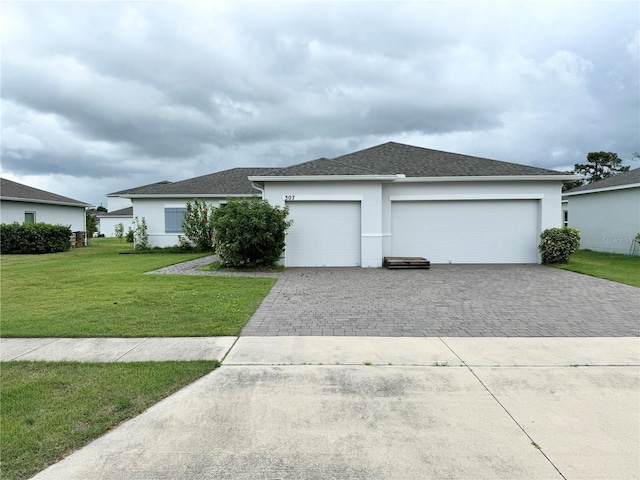 view of front of home with a front lawn and a garage