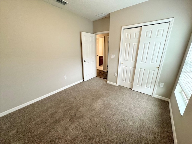 unfurnished bedroom featuring a closet and carpet floors