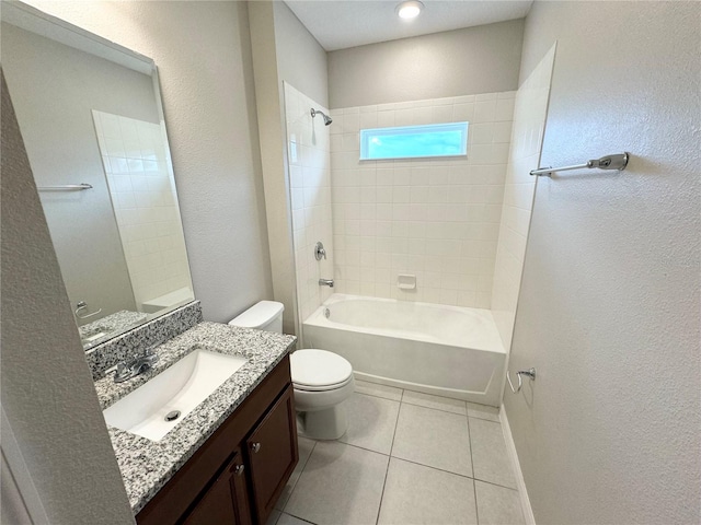 full bathroom featuring tile patterned floors, tiled shower / bath combo, vanity, and toilet