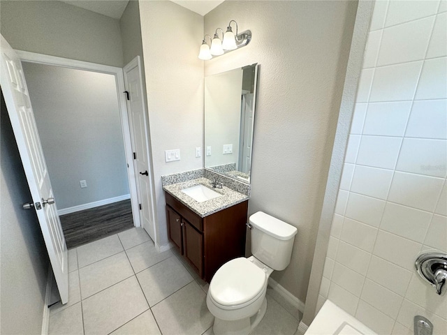 bathroom featuring tile patterned flooring, walk in shower, vanity, and toilet