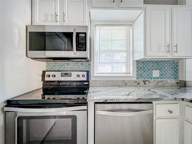 kitchen featuring appliances with stainless steel finishes and white cabinets