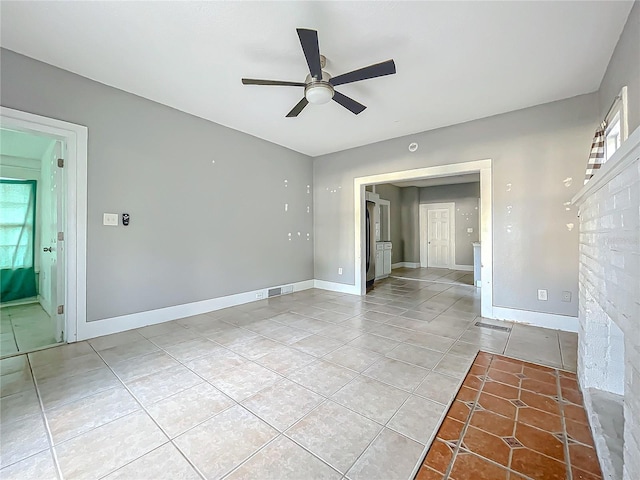 spare room with plenty of natural light, light tile patterned flooring, and ceiling fan