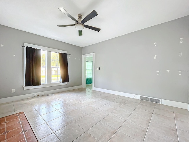 empty room with light tile patterned floors and ceiling fan