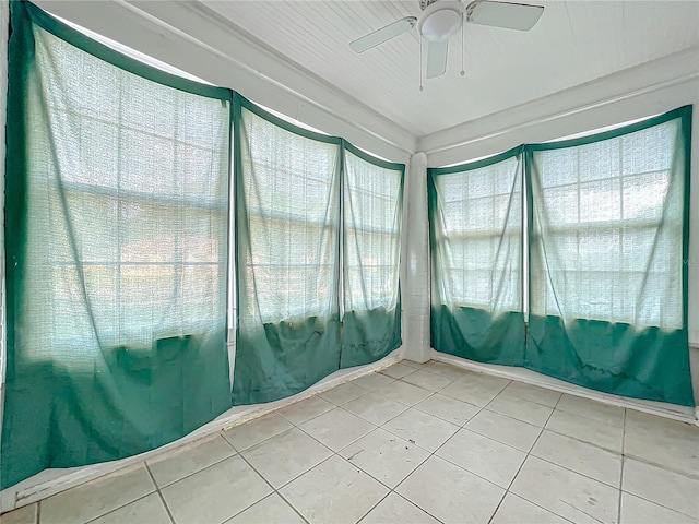 unfurnished sunroom with ceiling fan and a wealth of natural light