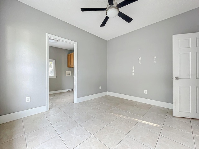 tiled empty room with ceiling fan