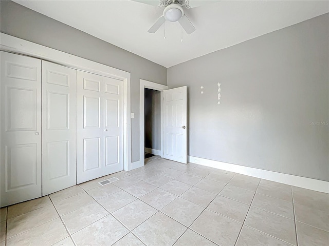 unfurnished bedroom with a closet, ceiling fan, and light tile patterned floors