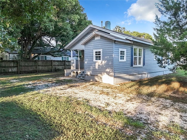 rear view of house with a yard