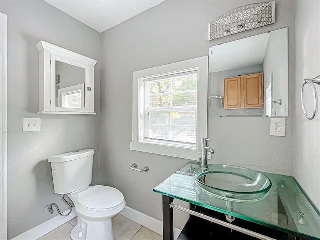 bathroom featuring vanity, tile patterned floors, and toilet