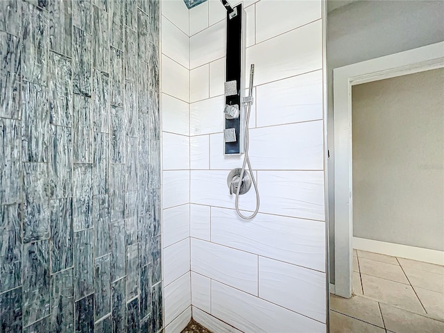 bathroom with a tile shower and tile patterned floors