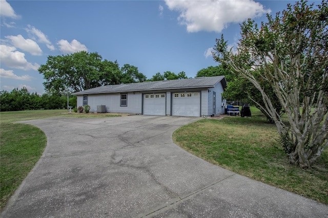 garage featuring a yard and central AC