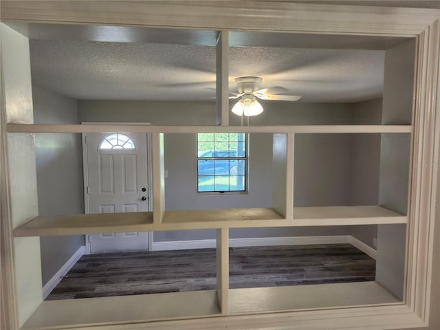 foyer featuring ceiling fan, a textured ceiling, and hardwood / wood-style floors