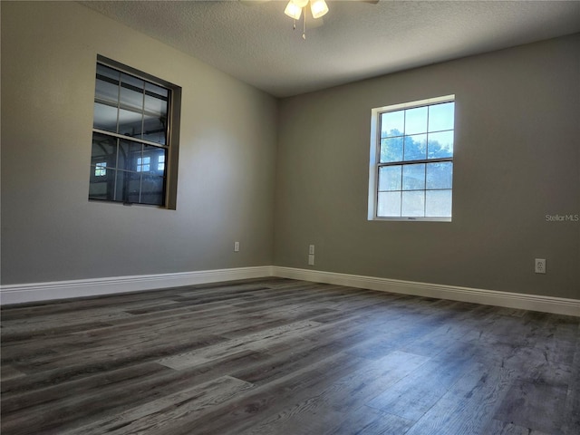 unfurnished room with a textured ceiling, dark hardwood / wood-style floors, and ceiling fan