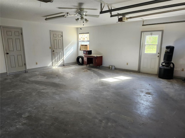 garage featuring a garage door opener, ceiling fan, and cooling unit