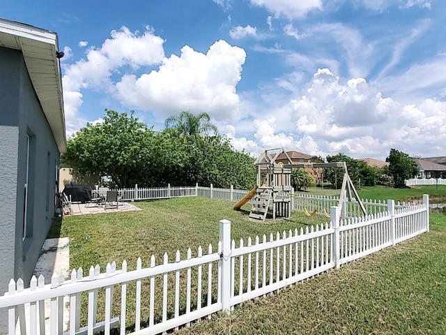 view of yard with a patio and a playground