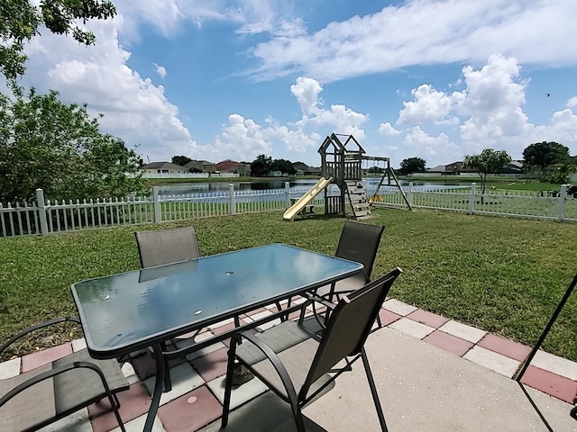 view of patio featuring a water view and a playground