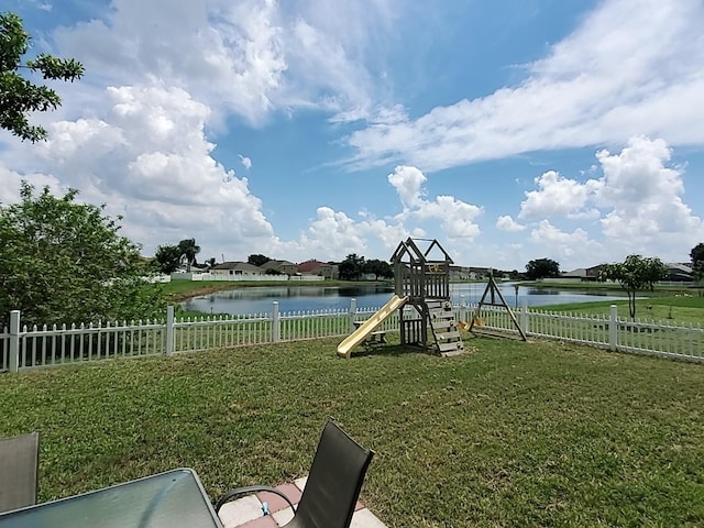 exterior space with a water view and a playground