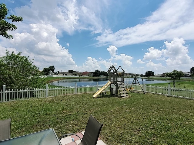714 Hacienda Cir, Kissimmee, FL 34741 - view of yard with a playground, a water view, and fence
