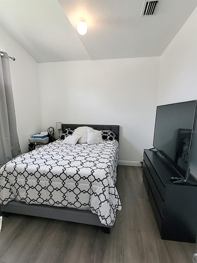 bedroom with dark wood-type flooring