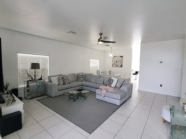 tiled living room with ceiling fan