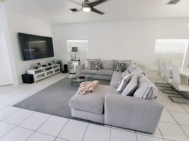 living room with ceiling fan and light tile patterned flooring