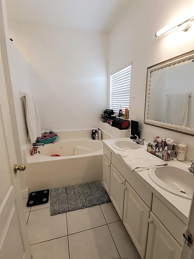 bathroom with vanity, a bathtub, and tile patterned flooring